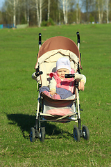 Image showing little baby smiling in the perambulator