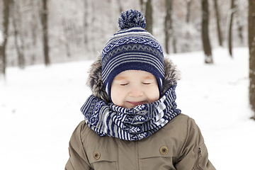 Image showing Child in winter, portrait squint blink