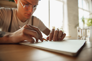 Image showing Close up of male hands writing on an empty paper, education and business concept