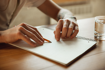 Image showing Close up of male hands writing on an empty paper, education and business concept