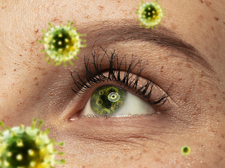 Image showing Close up shoot of a female eye with 3D-illustrated coronavirus models, the way of infecting