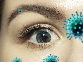Image showing Close up shoot of a female eye with 3D-illustrated coronavirus models, the way of infecting