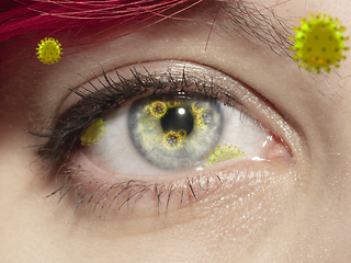 Image showing Close up shoot of a female eye with 3D-illustrated coronavirus models, the way of infecting