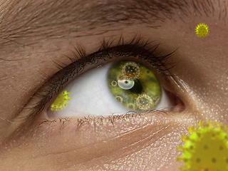 Image showing Close up shoot of a male eye with 3D-illustrated coronavirus models, the way of infecting