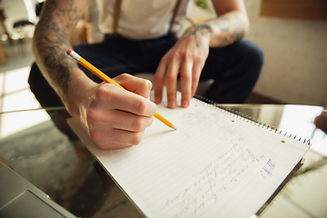 Image showing Close up of male hands writing on an empty paper, education and business concept