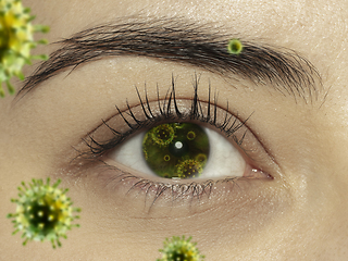 Image showing Close up shoot of a female eye with 3D-illustrated coronavirus models, the way of infecting