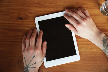 Image showing Close up of male hands using tablet with blank screen, copyspace, education and business concept, top view