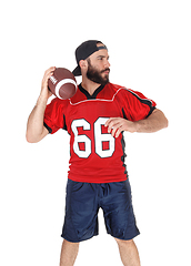 Image showing A football player in his jersey throwing the ball