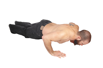 Image showing Young man doing punch-ups on the floor