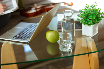 Image showing Young woman studying at home during online courses or free information by herself, focus on table