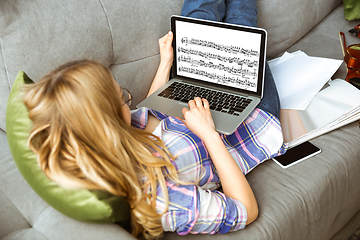 Image showing Young woman studying at home during online courses or free information by herself