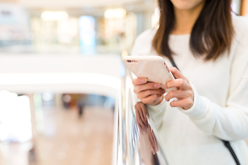 Image showing Woman sending sms on cellphone