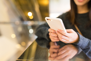 Image showing Woman sending text message on mobile phone