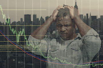 Image showing Stressed man holding head with hands on abstract city background. Double exposure with graphs. Virus alert, coronavirus pandemic, crisis, unemployment