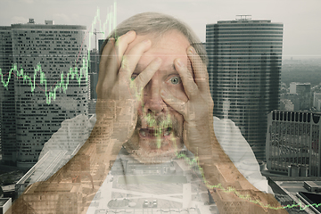Image showing Stressed senior man holding head with hands on abstract city background. Double exposure with graphs. Virus alert, coronavirus pandemic, crisis, unemployment