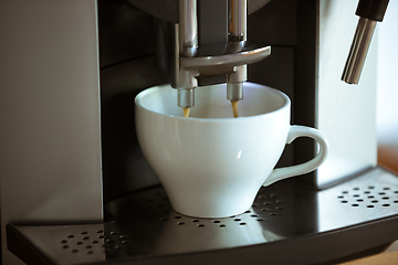 Image showing Close up of coffee machine pouring cappuccino, espresso, americano in white cup