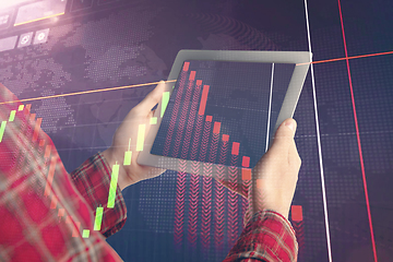 Image showing Hands holding tablet showing graphs going down. Double exposure with graphs, digital. Virus alert, coronavirus pandemic, crisis, unemployment