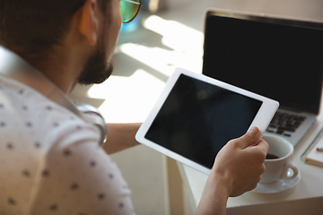 Image showing Man working from home during coronavirus or COVID-19 quarantine, remote office concept