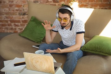 Image showing Man working from home during coronavirus or COVID-19 quarantine, remote office concept