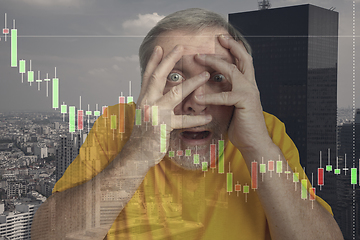 Image showing Stressed senior man holding head with hands on abstract city background. Double exposure with graphs. Virus alert, coronavirus pandemic, crisis, unemployment