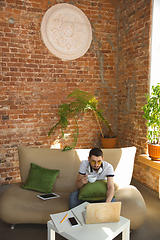 Image showing Man working from home during coronavirus or COVID-19 quarantine, remote office concept