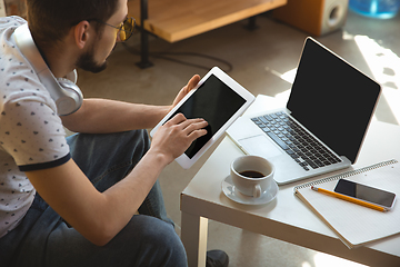 Image showing Man working from home during coronavirus or COVID-19 quarantine, remote office concept