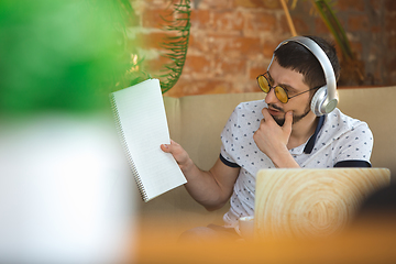 Image showing Man working from home during coronavirus or COVID-19 quarantine, remote office concept