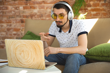 Image showing Man working from home during coronavirus or COVID-19 quarantine, remote office concept