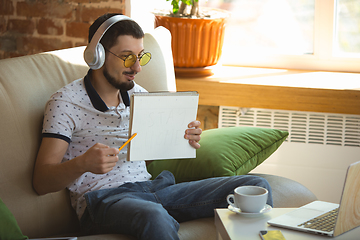 Image showing Man working from home during coronavirus or COVID-19 quarantine, remote office concept