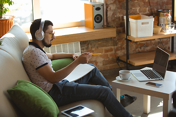 Image showing Man working from home during coronavirus or COVID-19 quarantine, remote office concept