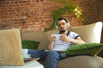 Image showing Man working from home during coronavirus or COVID-19 quarantine, remote office concept