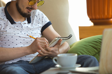 Image showing Man working from home during coronavirus or COVID-19 quarantine, remote office concept