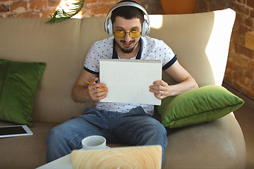 Image showing Man working from home during coronavirus or COVID-19 quarantine, remote office concept