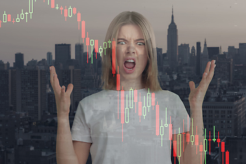 Image showing Stressed woman holding head with hands on abstract city background. Double exposure with graphs. Virus alert, coronavirus pandemic, crisis, unemployment