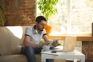 Image showing Man working from home during coronavirus or COVID-19 quarantine, remote office concept