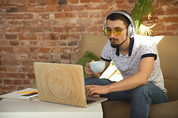 Image showing Man working from home during coronavirus or COVID-19 quarantine, remote office concept