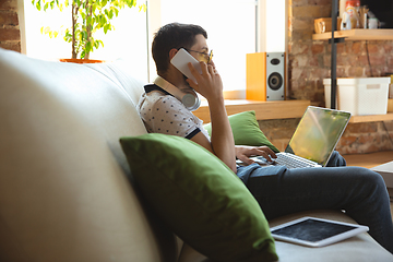 Image showing Man working from home during coronavirus or COVID-19 quarantine, remote office concept