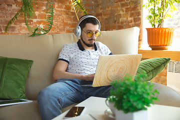 Image showing Man working from home during coronavirus or COVID-19 quarantine, remote office concept