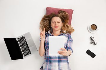 Image showing Emotional caucasian woman using gadgets isolated on white studio background, technologies connecting people. Online meeting, selfie