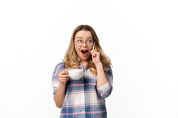 Image showing Emotional caucasian woman using smartphone isolated on white studio background, technologies. Talking shocked