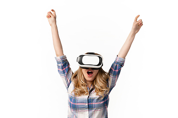 Image showing Emotional caucasian woman using VR-headsed isolated on white studio background, technologies. Winning
