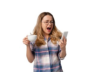 Image showing Emotional caucasian woman using smartphone isolated on white studio background, technologies. Scared screaming