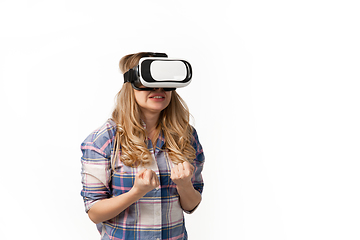 Image showing Emotional caucasian woman using VR-headsed isolated on white studio background, technologies. Scared