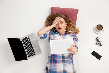 Image showing Emotional caucasian woman using gadgets isolated on white studio background, technologies connecting people. Online shopping, selfie, gaming