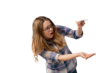 Image showing Emotional caucasian woman using smartphone isolated on white studio background, technologies. Spilled coffee