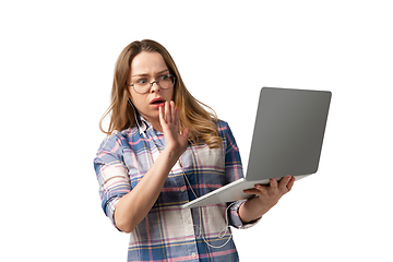 Image showing Emotional caucasian woman using laptop on white studio background, technologies. Disguasted rejecting