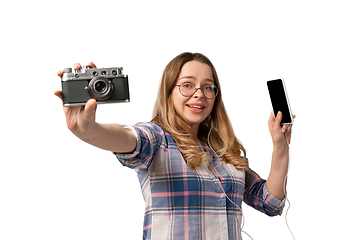 Image showing Emotional caucasian woman using gadgets on white studio background, technologies. Shows camera and smartphone