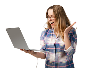 Image showing Emotional caucasian woman using laptop on white studio background, technologies. Crazy happy