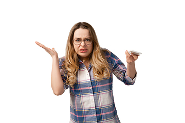 Image showing Emotional caucasian woman using smartphone isolated on white studio background, technologies. Disguasted