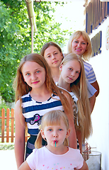 Image showing Girls of different ages and growth. Feminine children and adults